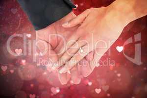Composite image of close-up of bride and groom with hands togeth