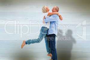 Composite image of mature couple hugging and having fun