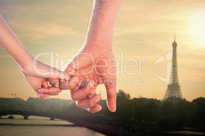 Composite image of loving young couple holding hands