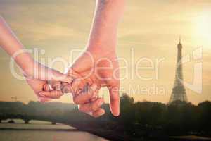Composite image of loving young couple holding hands
