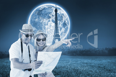 Composite image of happy tourist couple using map and pointing