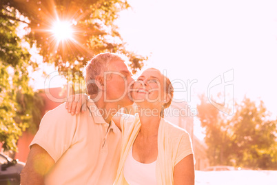 Happy senior couple embracing in the city