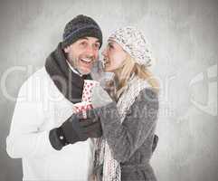 Composite image of happy couple in winter fashion holding mugs