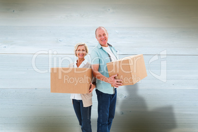 Composite image of older couple smiling at camera holding moving