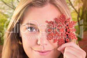 Composite image of festive blonde holding a snowflake