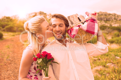 Cute couple going for a picnic with woman kissing boyfriends che