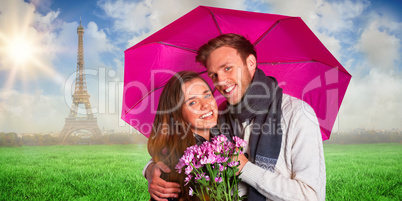 Composite image of cheerful young couple with flowers and umbrel