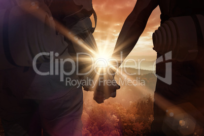 Composite image of hitch hiking couple standing holding hands on