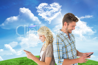 Composite image of attractive couple using their smartphones