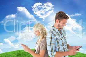 Composite image of attractive couple using their smartphones