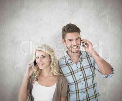 Composite image of attractive couple talking on their smartphone