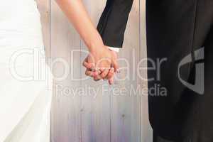 Composite image of close up of cute young newlyweds holding thei