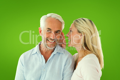 Composite image of woman whispering a secret to husband