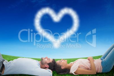 Composite image of attractive young couple lying down