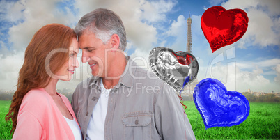 Composite image of casual couple hugging and smiling Composite image of casual couple hugging and smiling