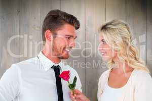 Composite image of handsome man smiling at girlfriend holding a