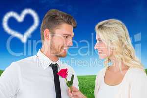 Composite image of handsome man smiling at girlfriend holding a