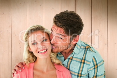 Composite image of handsome man kissing girlfriend on cheek