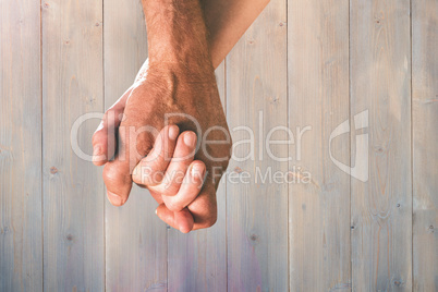 Composite image of happy senior couple holding hands