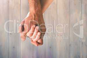 Composite image of happy senior couple holding hands