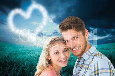 Composite image of attractive couple smiling at camera