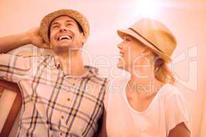 Young hip couple laughing on bench