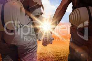 Composite image of hitch hiking couple standing holding hands on