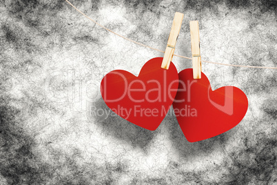 Composite image of hearts hanging on line