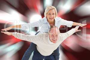 Composite image of happy mature couple having fun