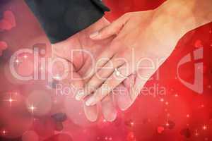 Composite image of close-up of bride and groom with hands togeth