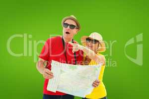 Composite image of happy tourist couple using map