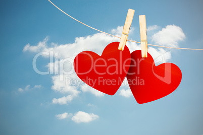 Composite image of hearts hanging on line