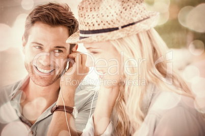 Cute couple listening to music together in cafe