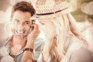 Cute couple listening to music together in cafe