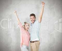 Composite image of attractive couple smiling and cheering