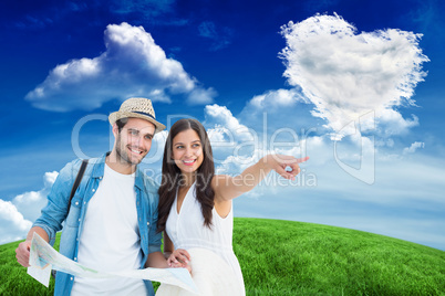 Composite image of happy hipster couple looking at map