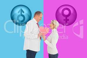 Composite image of older affectionate couple holding pink heart