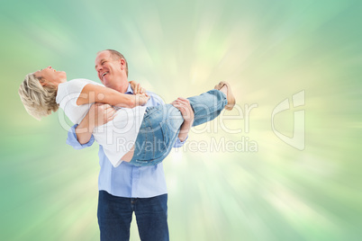 Composite image of mature man carrying his laughing partner