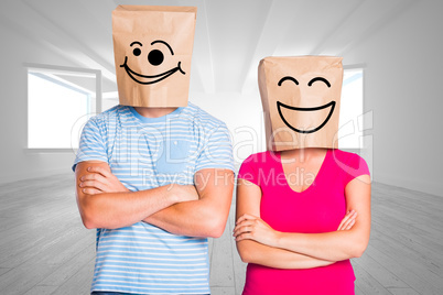 Composite image of young couple with bags over heads