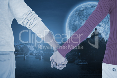 Composite image of couple holding hands rear view