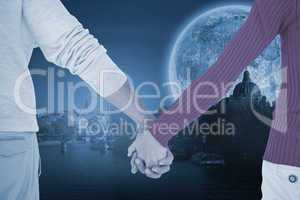 Composite image of couple holding hands rear view