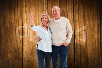 Composite image of happy mature couple walking together