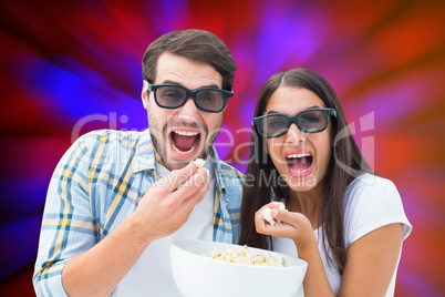 Composite image of attractive young couple watching a 3d movie