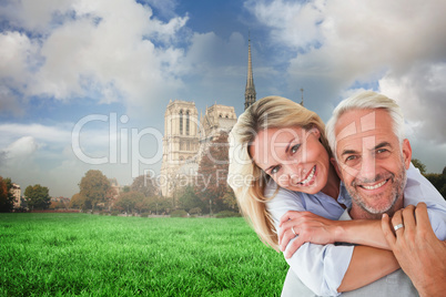 Composite image of happy couple standing and hugging