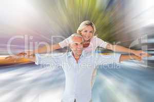 Composite image of smiling couple posing with arms out