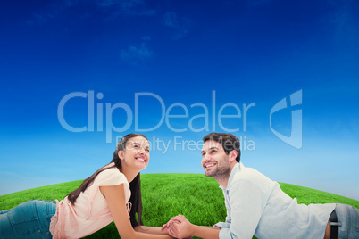 Composite image of attractive young couple looking up