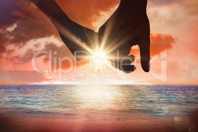 Composite image of loving young couple holding hands