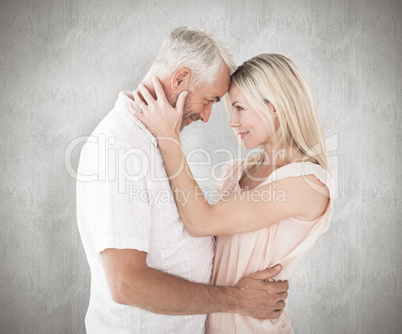 Composite image of affectionate couple standing and hugging