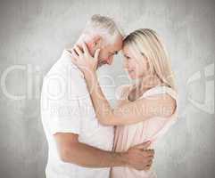 Composite image of affectionate couple standing and hugging