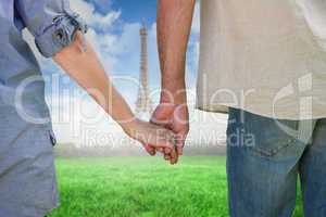 Composite image of couple holding hands in park